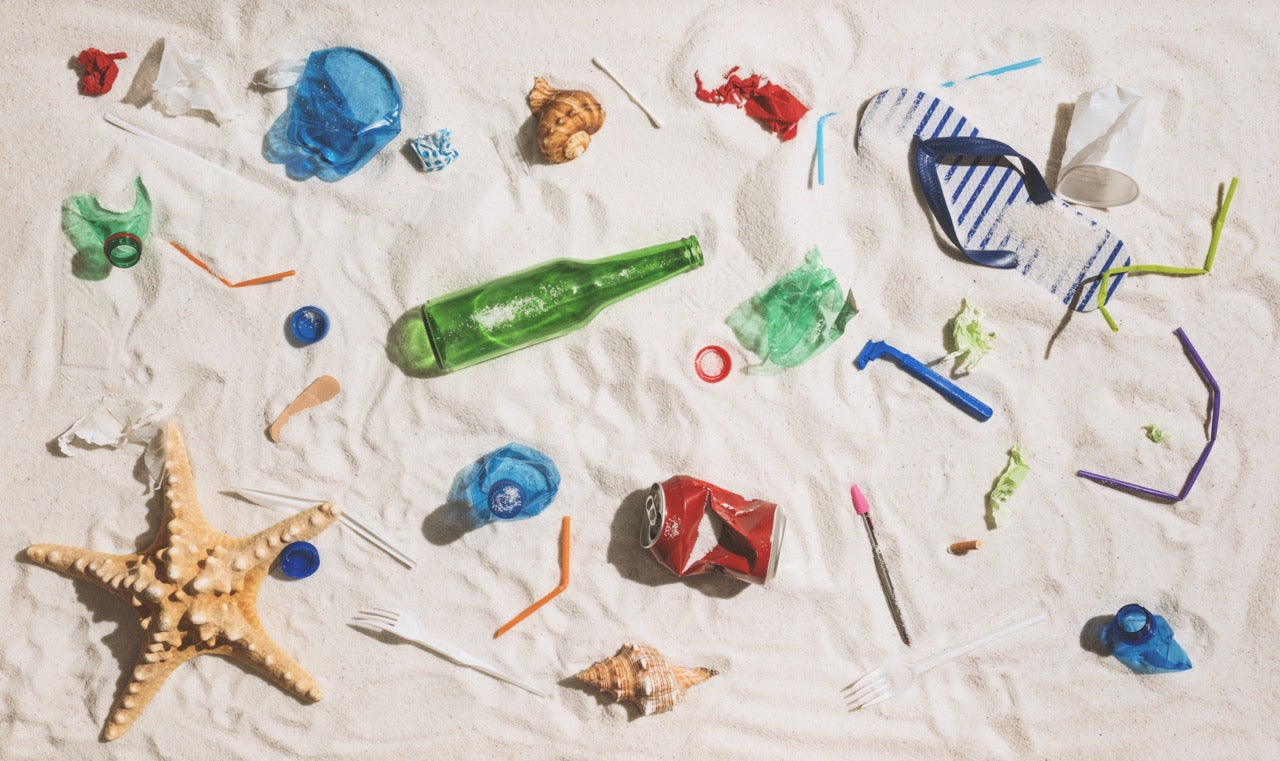 Plastic and glass waste on a beach