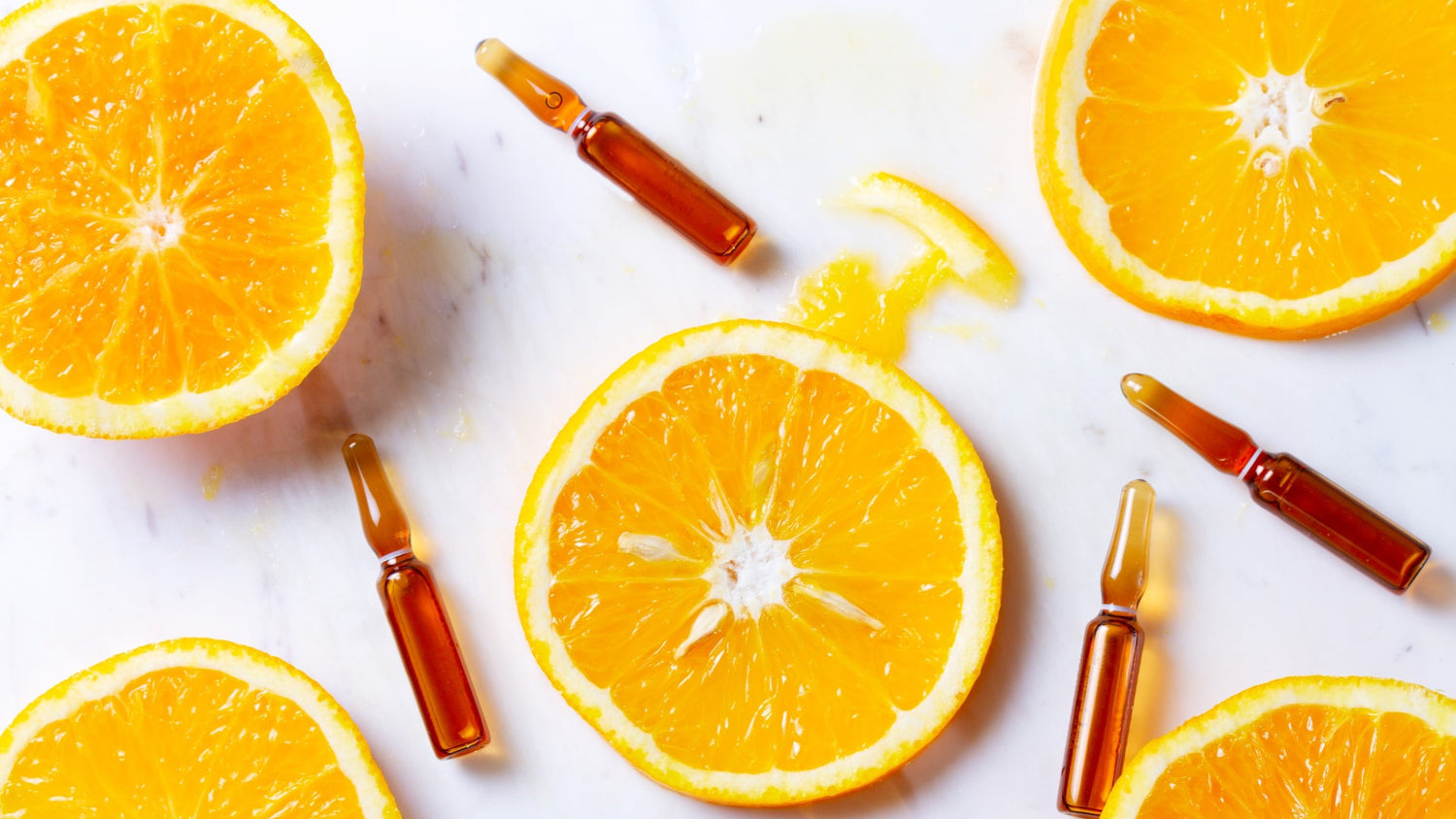 Photo of oranges slices and vials representing Vitamin C and Peptides